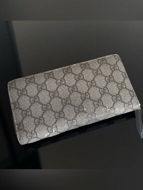 Gucci zip around long wallet in the classic GG Supreme canvas.
